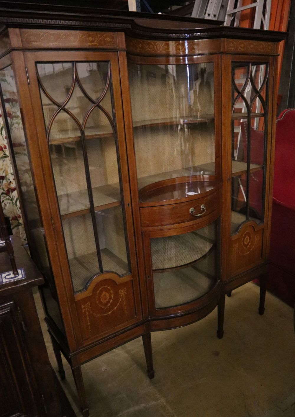 An Edwardian marquetry inlaid mahogany bow fronted display cabinet